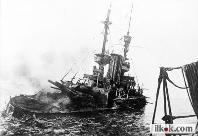 Her Majesty's Ship (HMS) Irresistible sinking after striking a Turkish mine on 18th March 1915 (photograph taken from HMS Nelson)